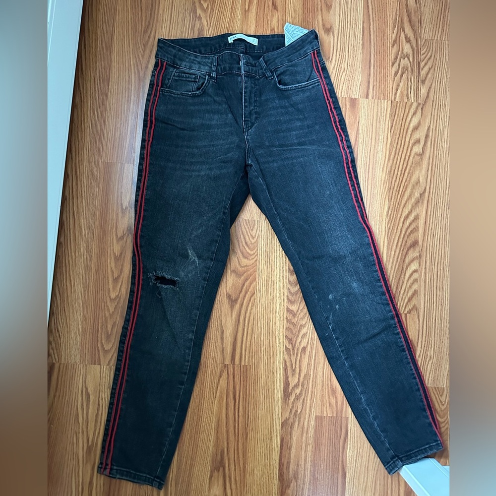 Black zara jeans, slightely distressed, and red stripes on side.